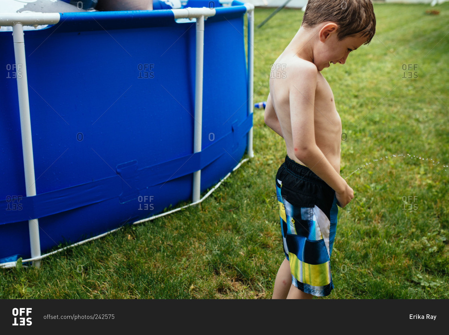 Little Boy Peeing By Pool In Backyard Stock Photo OFFSET