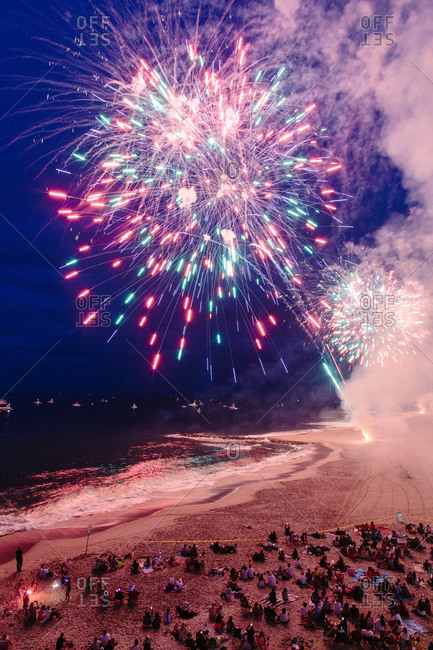 Crowds watching fireworks on beach