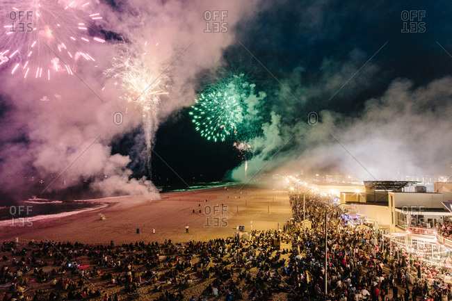 Crowds watching firework show on beach