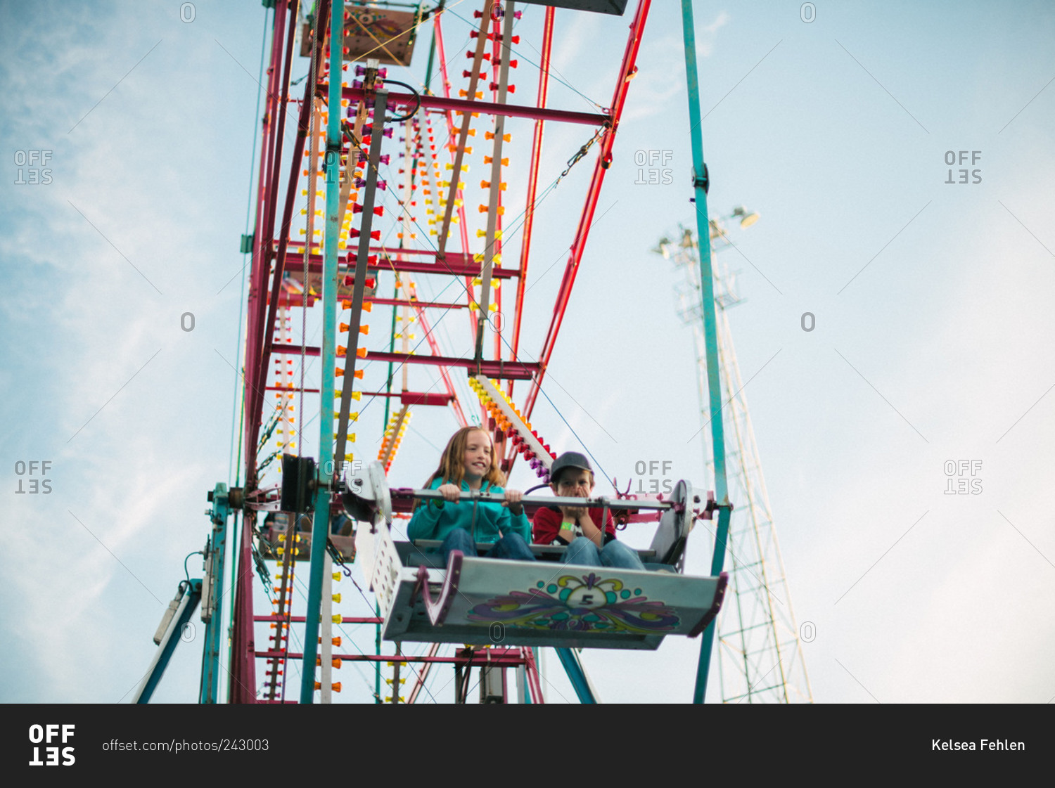 Boy and girl riding a ferris wheel