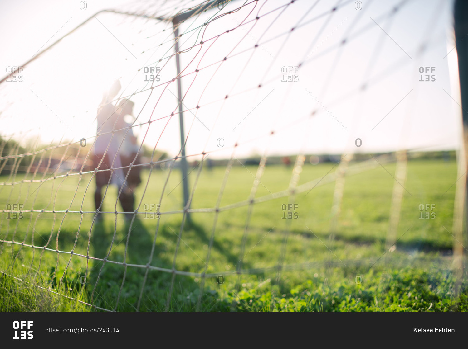 Young soccer players and goal