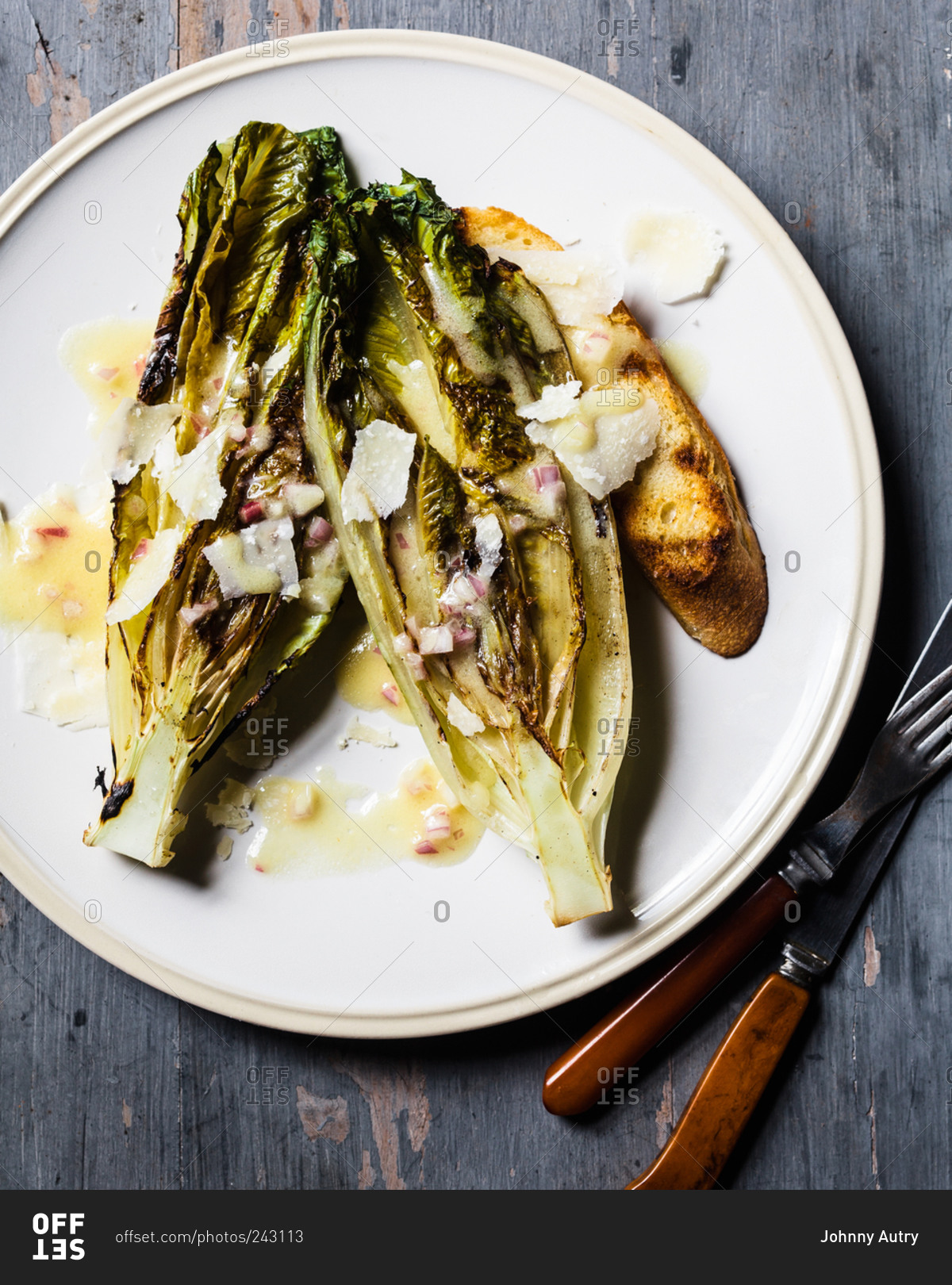 Grilled romaine with cheese and dressing and slice of toast