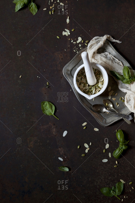 Mortar and pestle with pesto ingredients