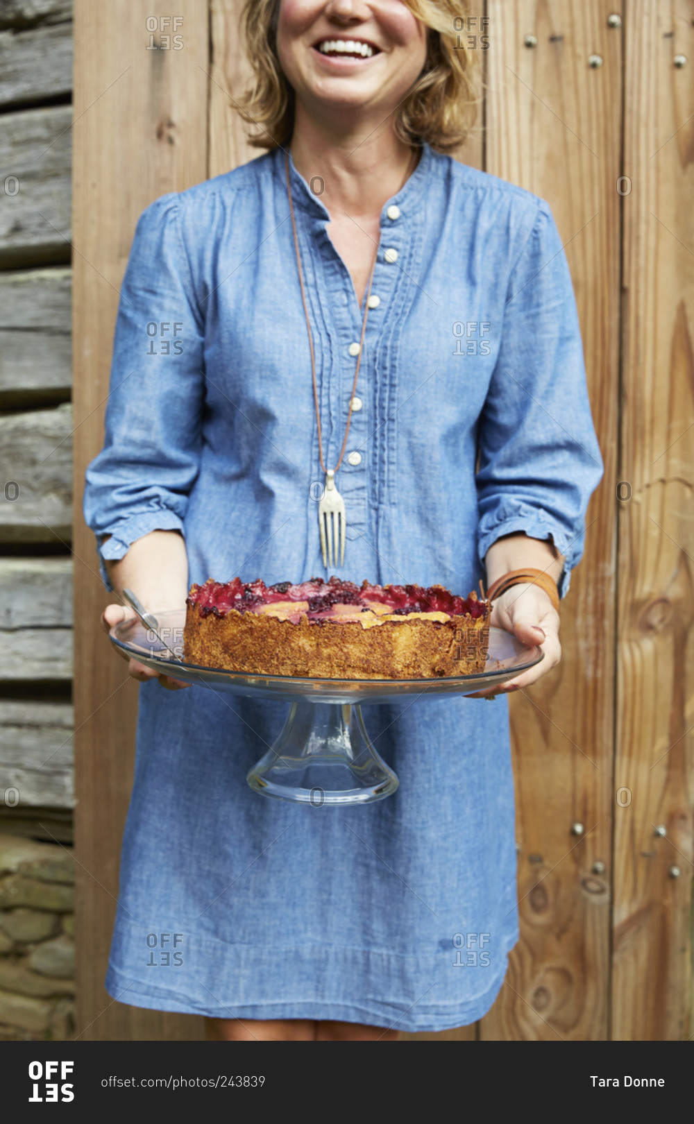Woman holding cake on cake stand