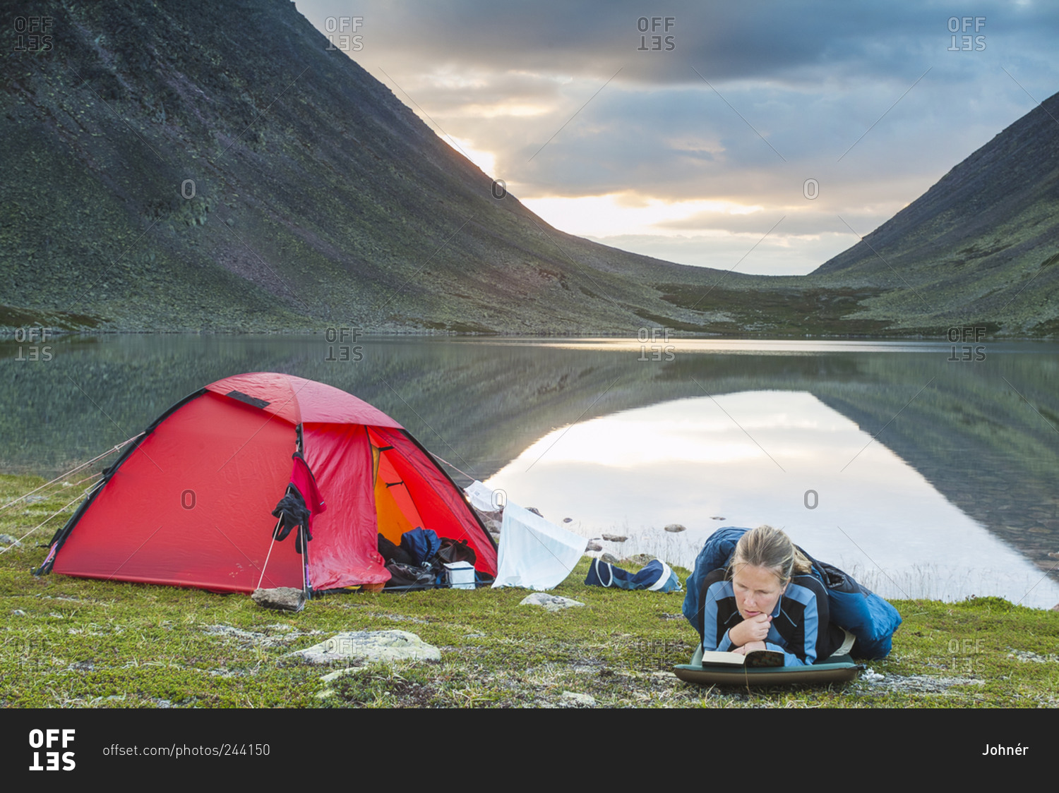 Mature woman camping at lake