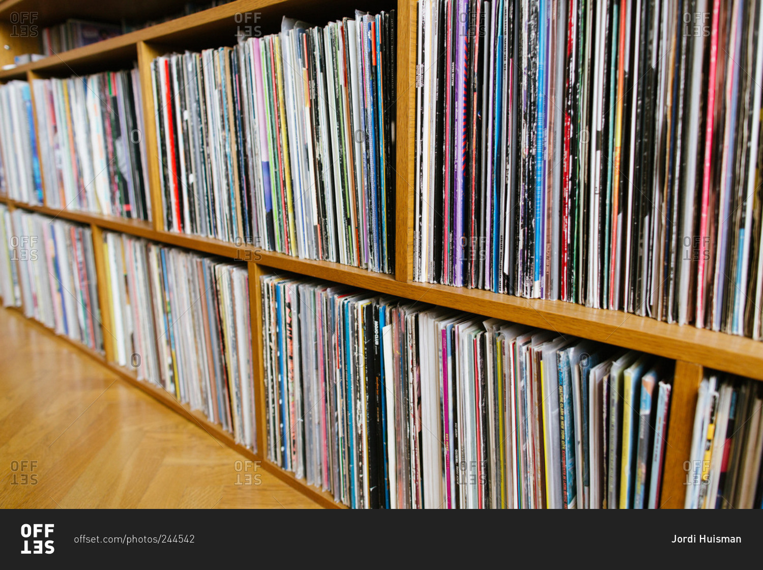 A record collection on a wooden shelf