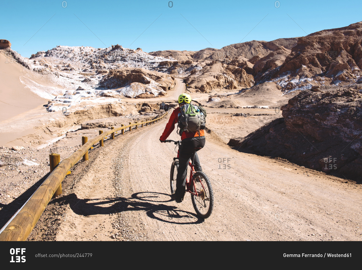 Man riding a mountain bike through the Valle de la Luna, Atacama Desert