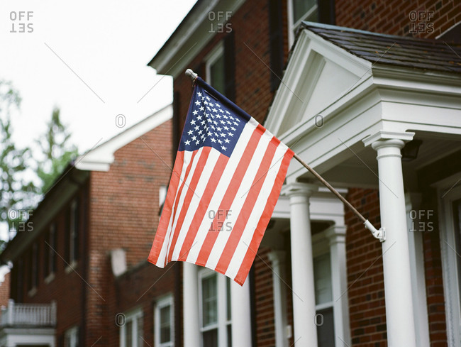 American flag hanging from a front porch