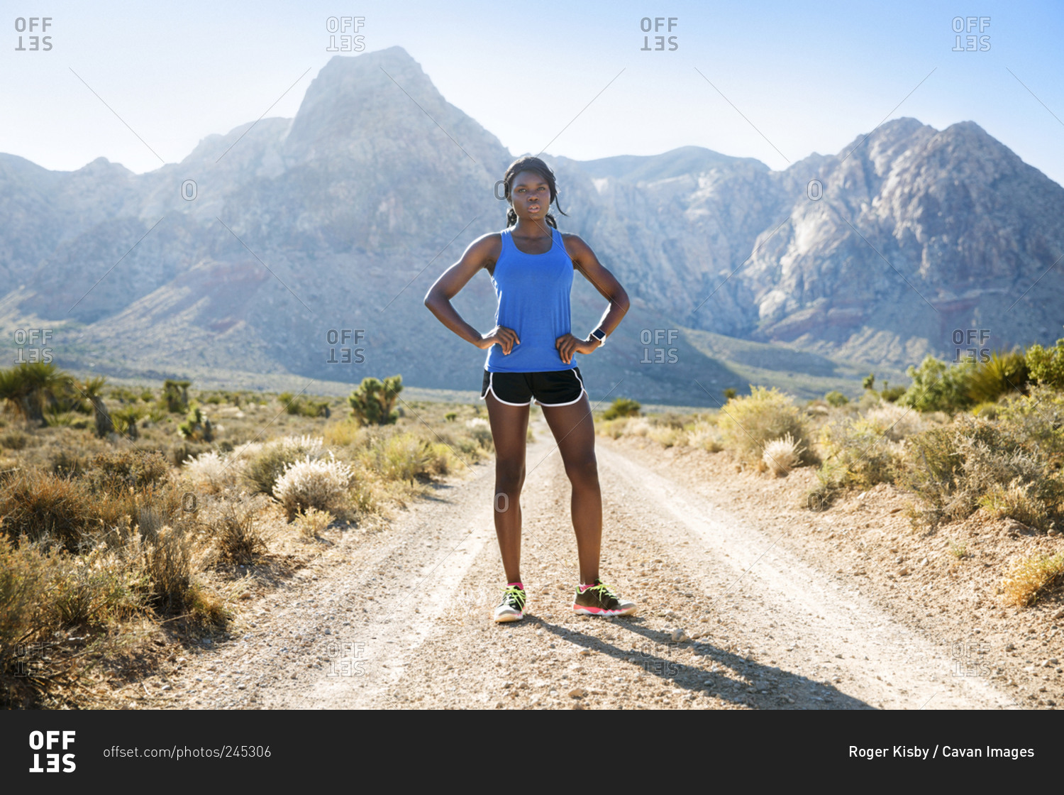 Athletic woman standing in mountain prairie
