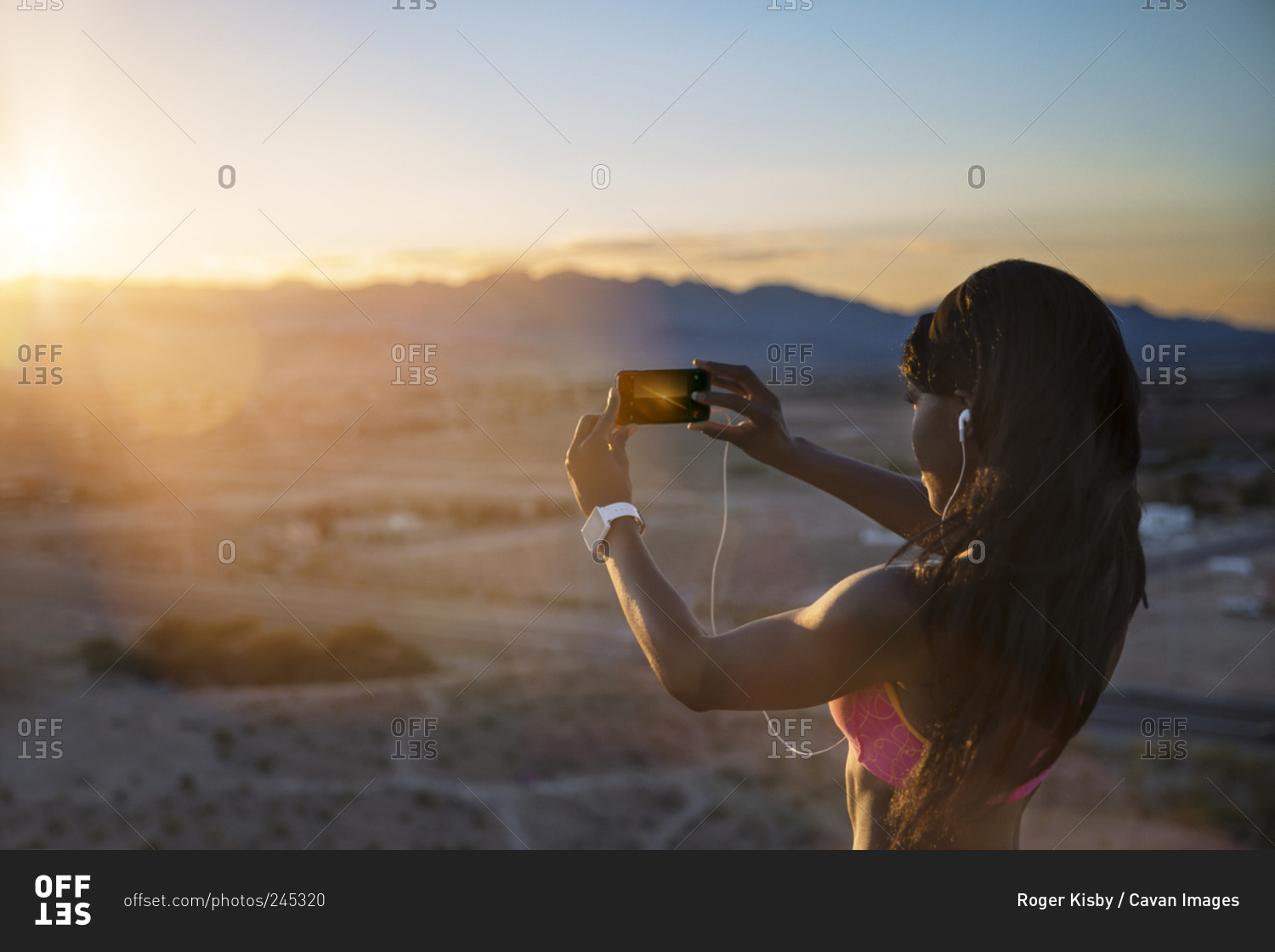Athletic woman taking picture of desert setting