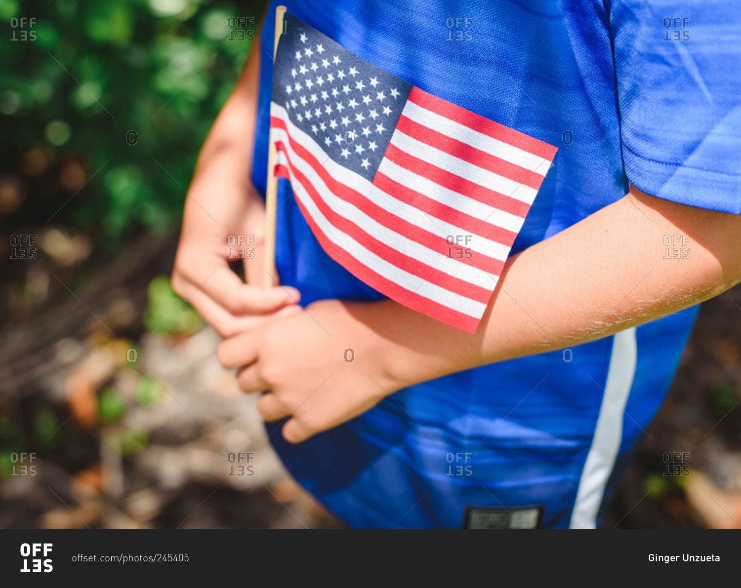 Close up of a young child's hands holding an American Flag