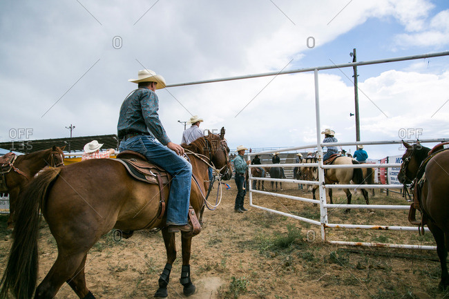 Taos, New Mexico, USA - June 28, 2015: Man on horseback entering a rodeo arena