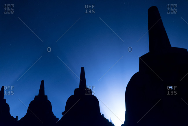 Stupas silhouetted at sunrise in Borobudur, Indonesia