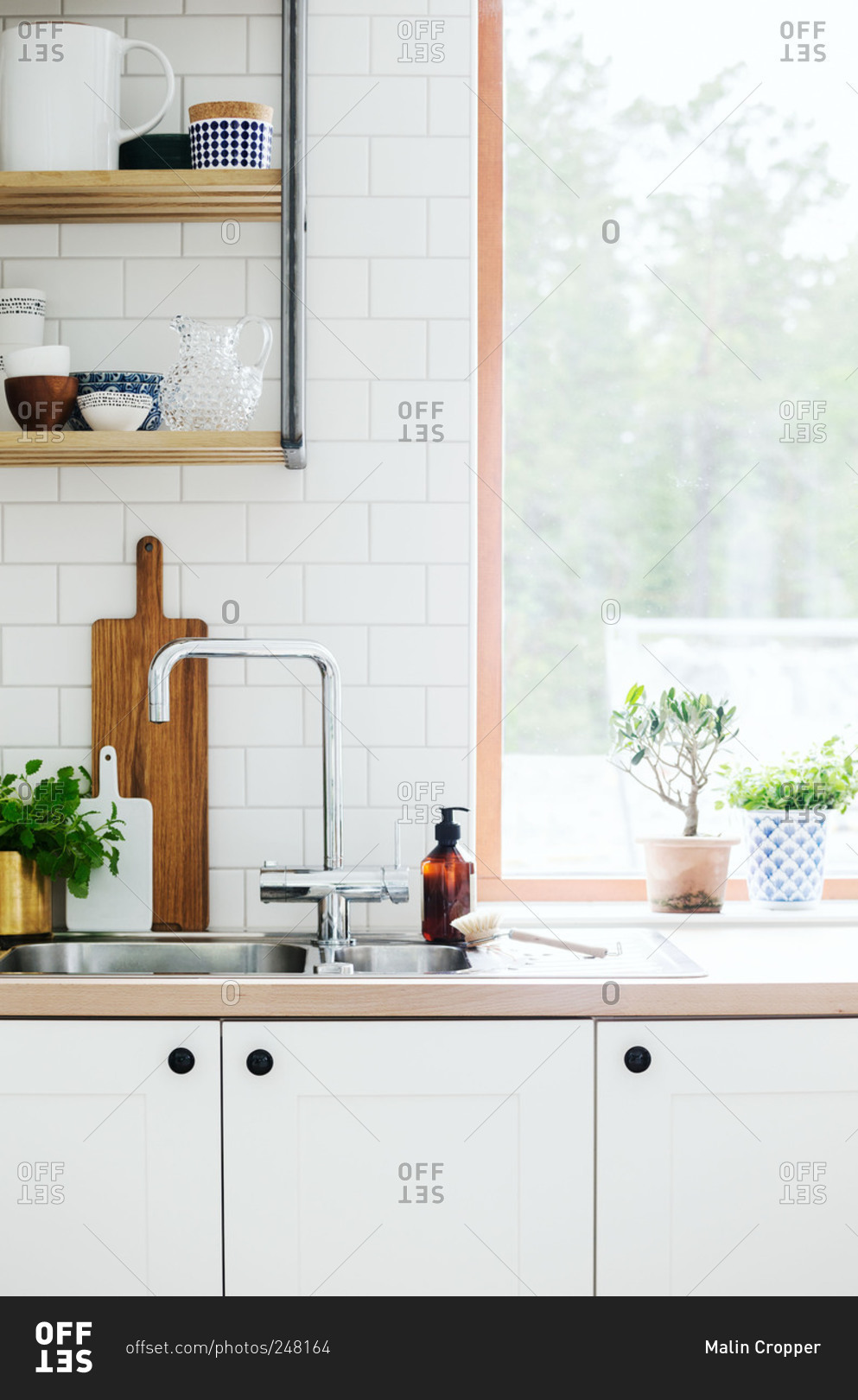 A white modern kitchen with subway tile in a home in Sweden