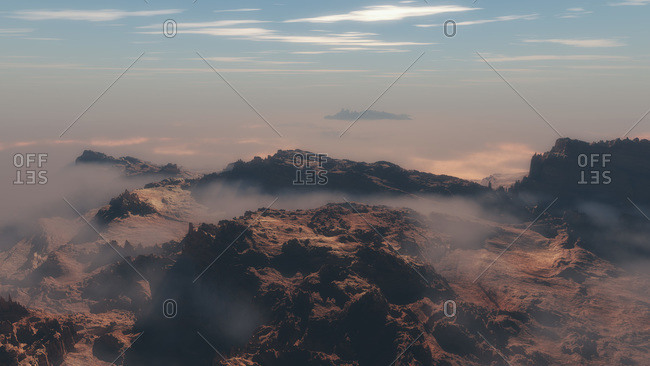 Mountains covered in thin layer of clouds