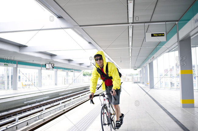 Man riding his bike in a subway station