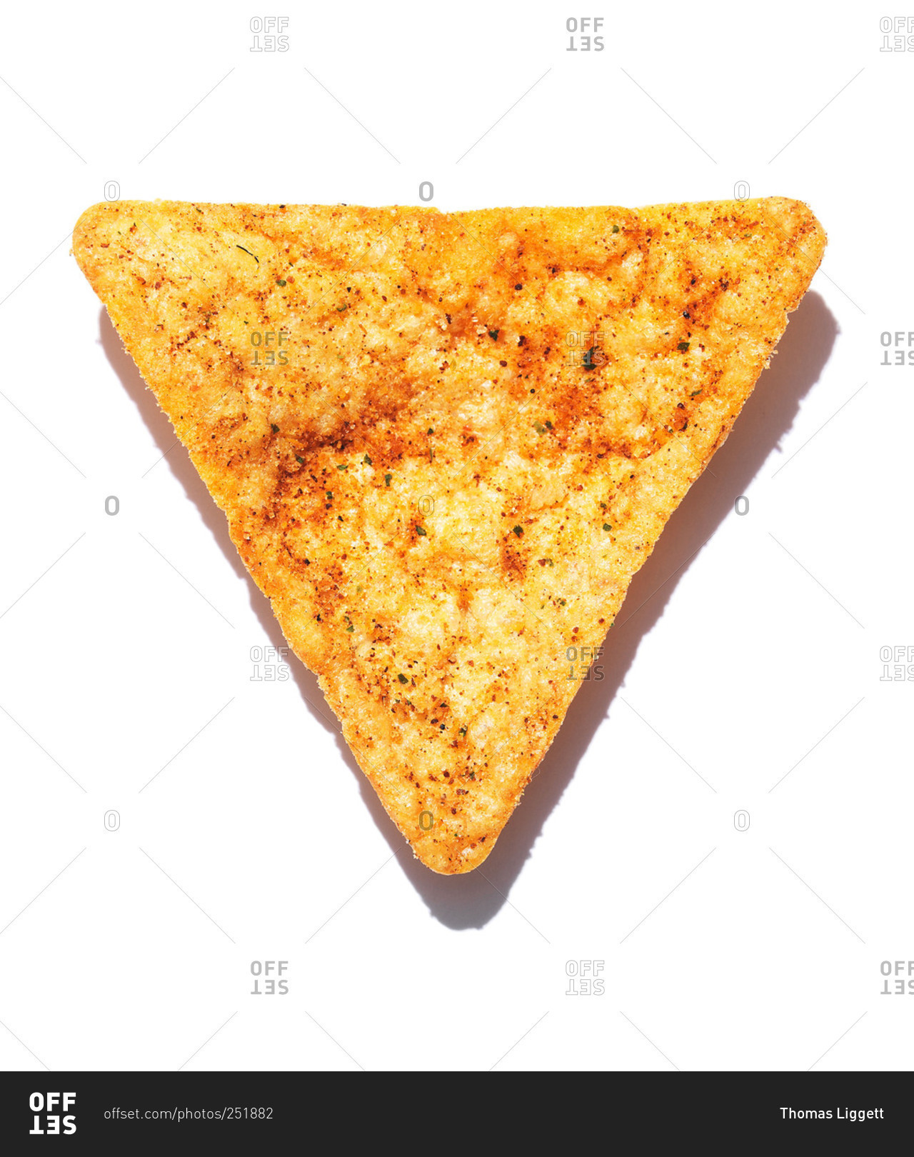 Whole Triangular Tortilla Chip Sprinkled With Seasoning Isolated On