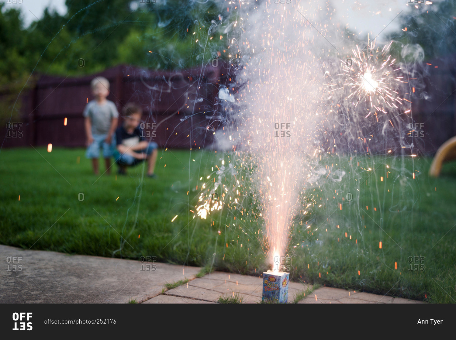 Fountain fireworks burning in a backyard
