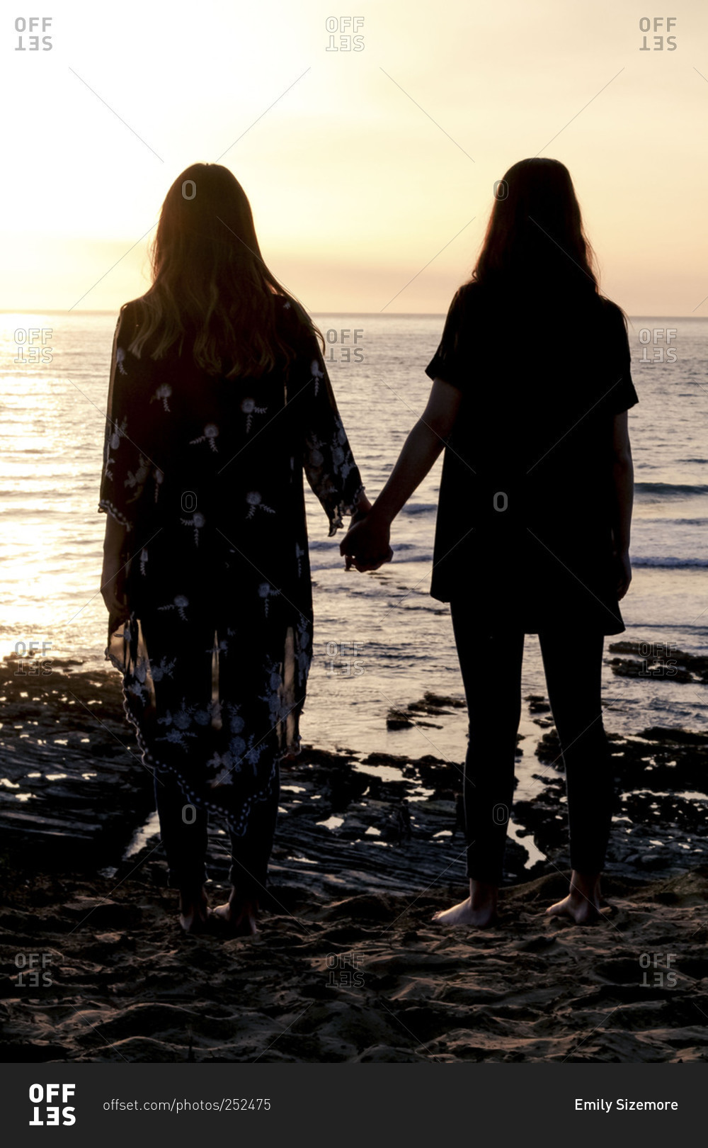 two girls holding hands silhouette