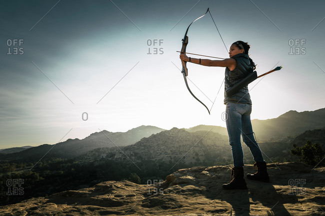 Woman pointing a crossbow