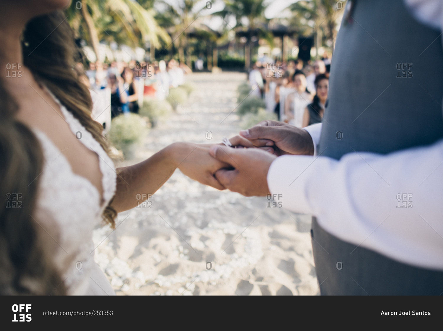 A husband and wife exchange wedding rings at a small ceremony on a ...