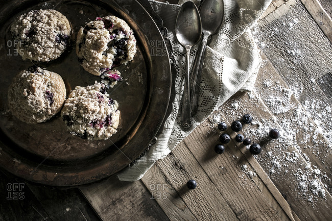 Overhead view of blueberry muffins on a rustic tabletop