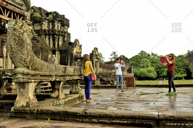 Angkor, Cambodia - September 15, 2012: Tourists take pictures in Angkor, Cambodia