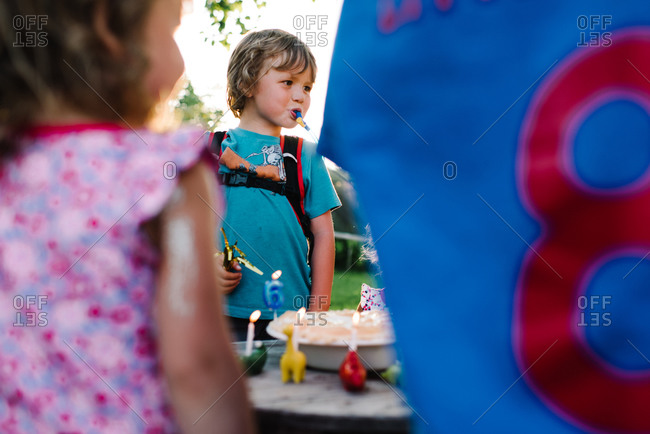 A boy celebrates his birthday outside