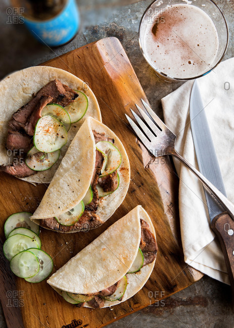 Grilled flank steak tacos with sliced cucumbers stock photo - OFFSET