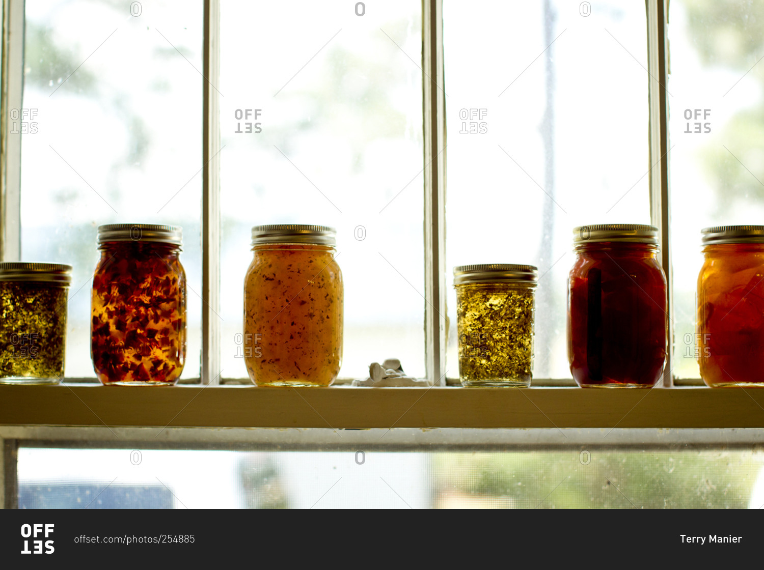 Jars of jellies and preserves on a window sill
