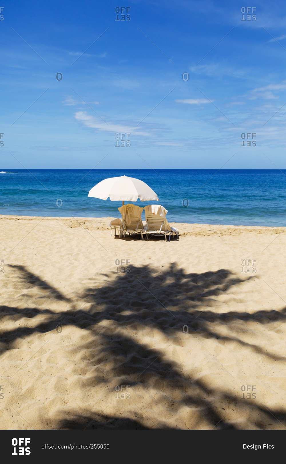 Beach chairs with umbrella on Hulupo'e Beach, Manele Bay, Lanai, Hawaii