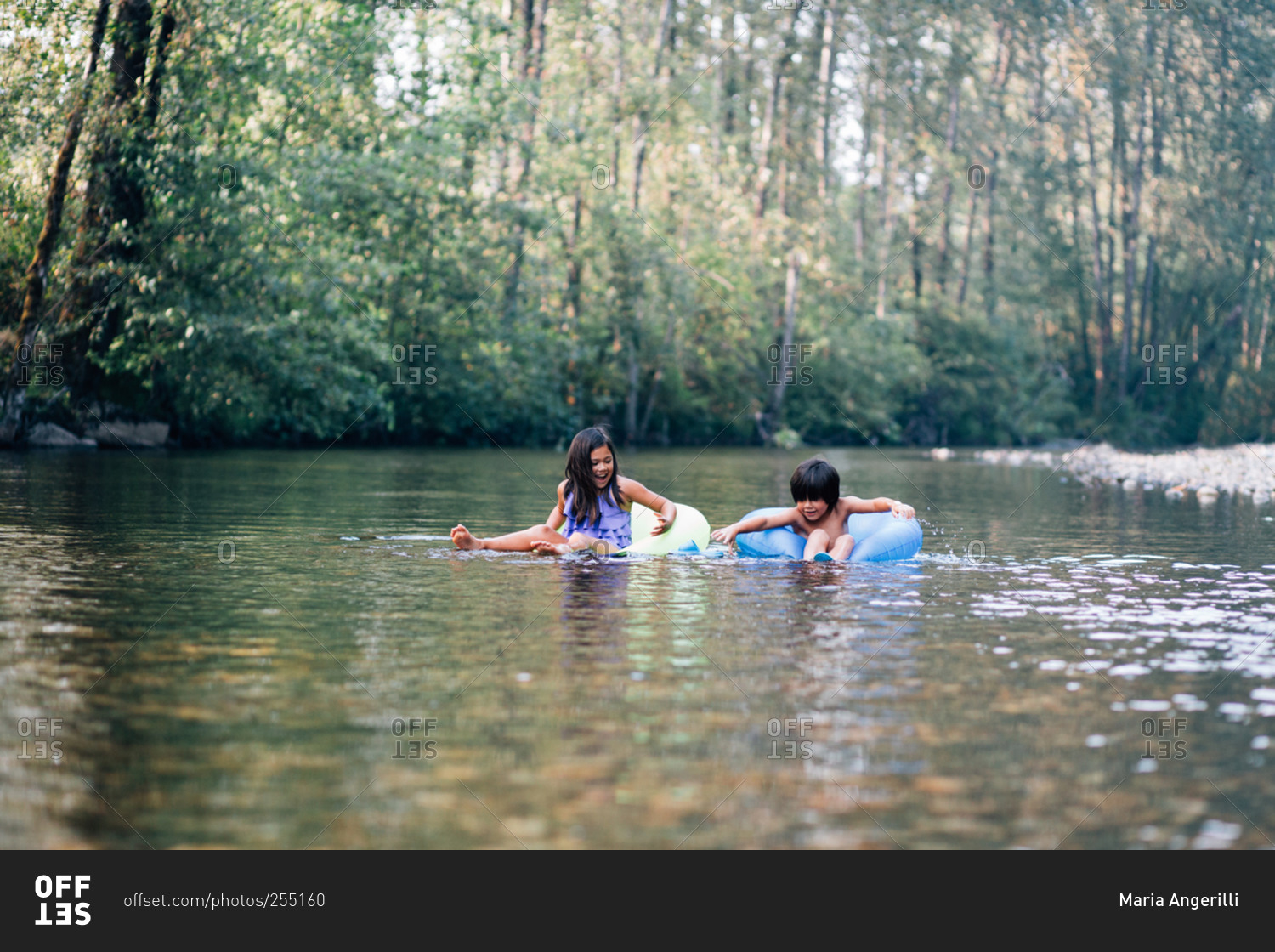Boy and girl on inner tubes on a river