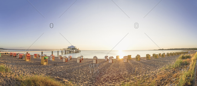 View to Timmendorfer Strand with hooded beach chairs and sea bridge, Niendorf