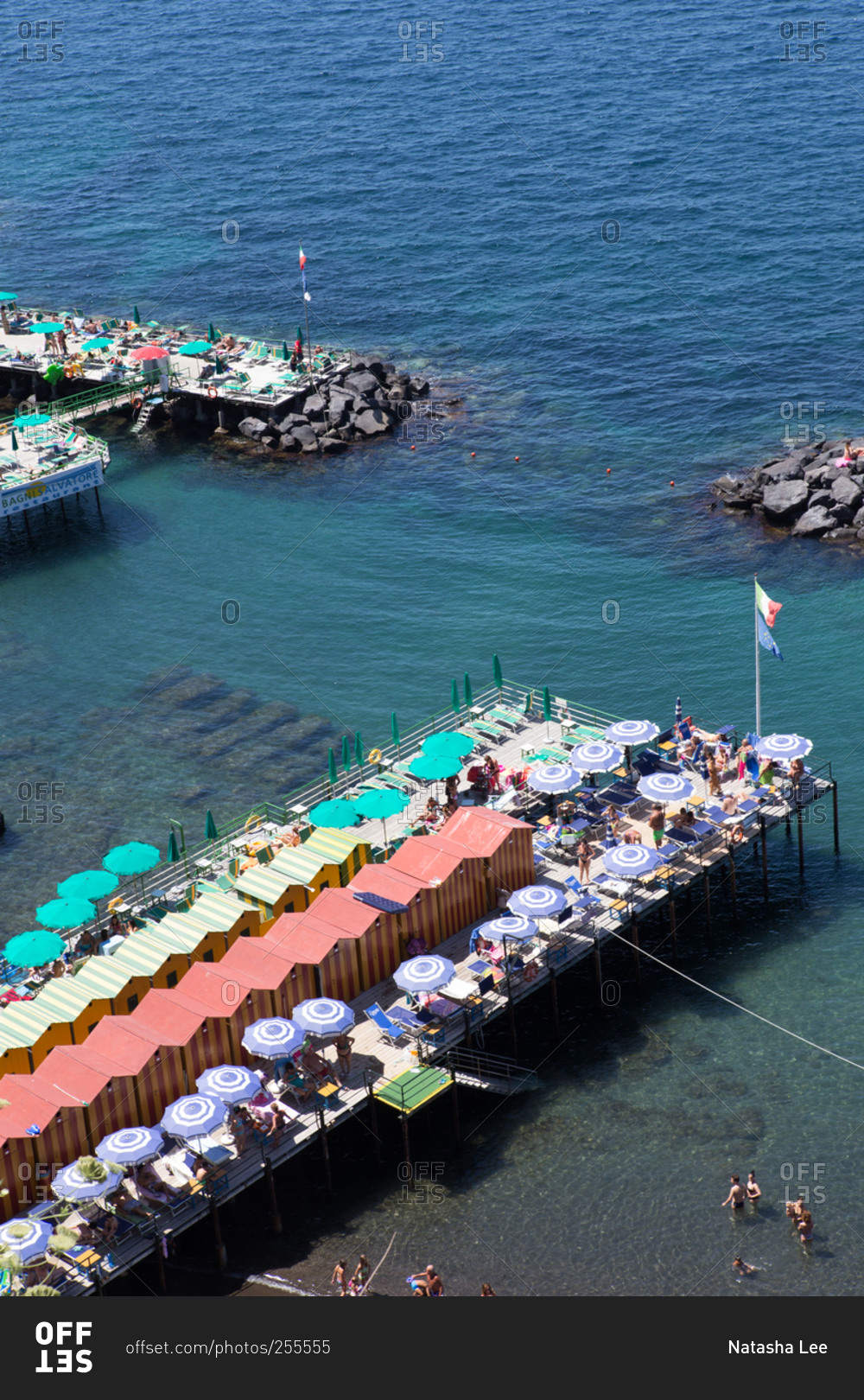 Sun bathers on a pier in Sorrento, Italy
