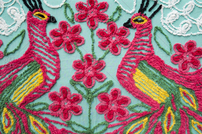 Peacock design embroidered on a blanket