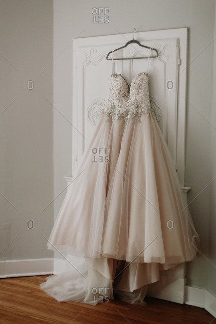 A Wedding Dress Hangs On A Door Frame Stock Photo Offset