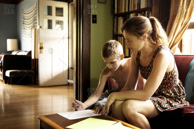 Woman checking son's homework