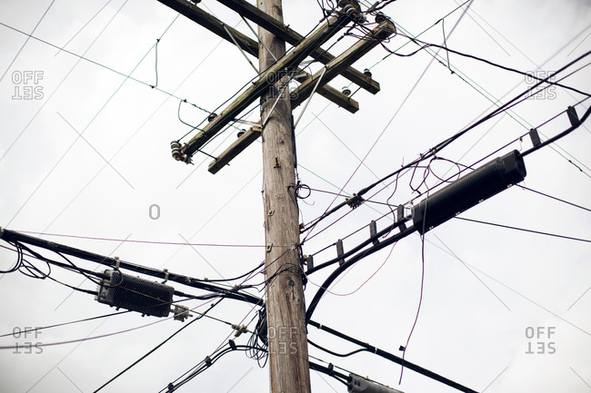 A telephone pole crowded with lines