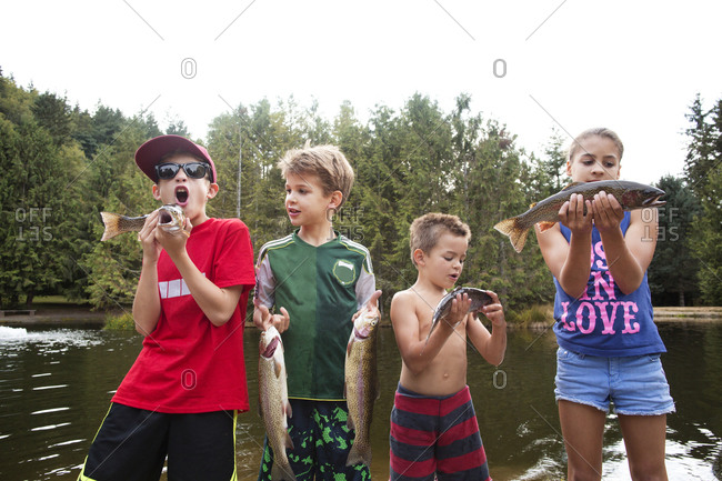 Group of kids holding up their fishing haul