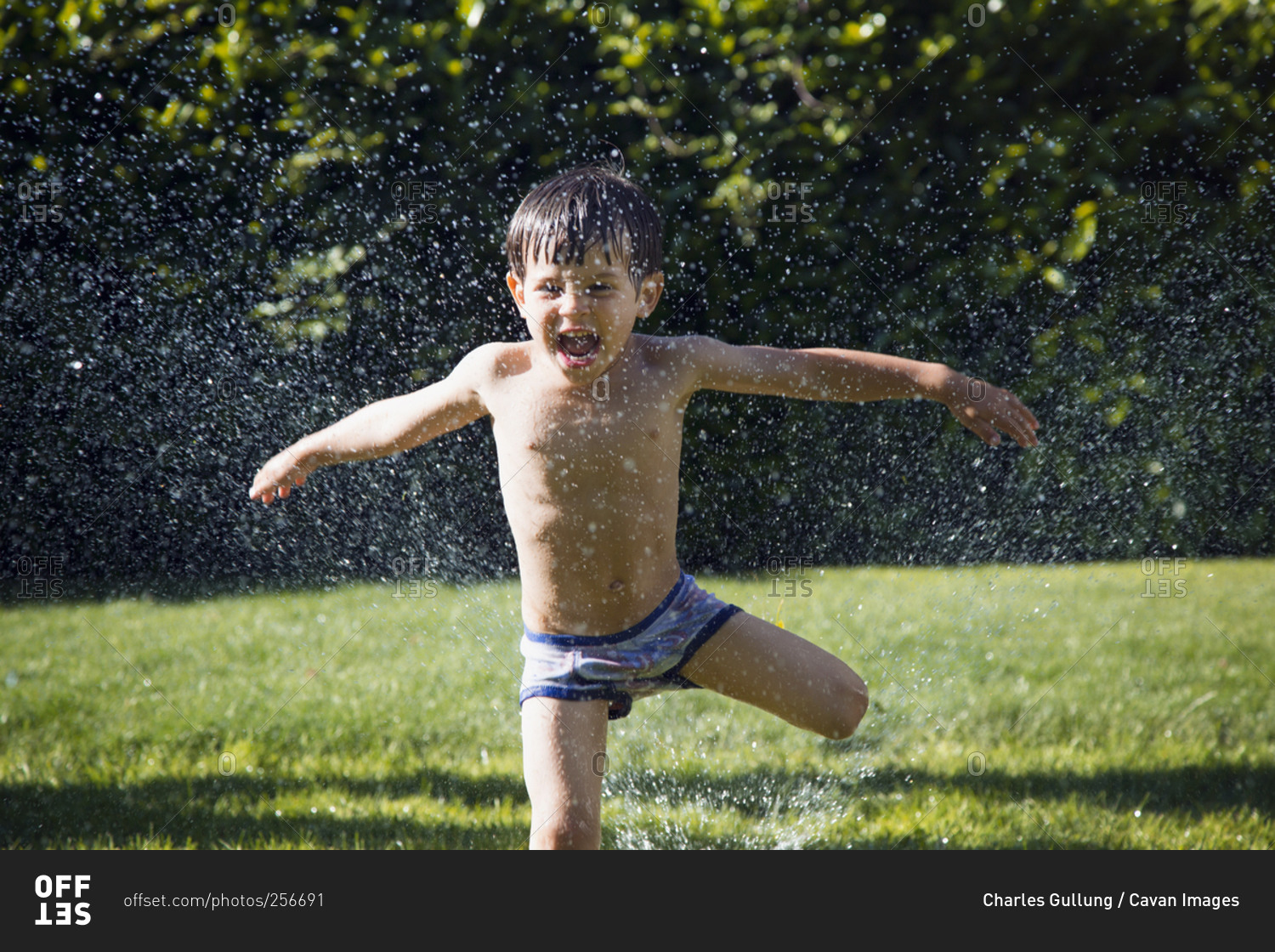 kids playing in sprinkler