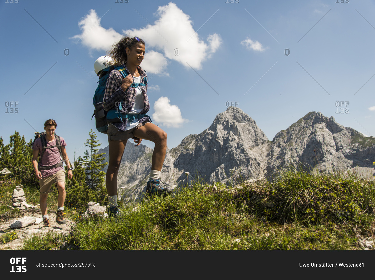 Young couple hiking on mountain trail, Tannheimer Tal