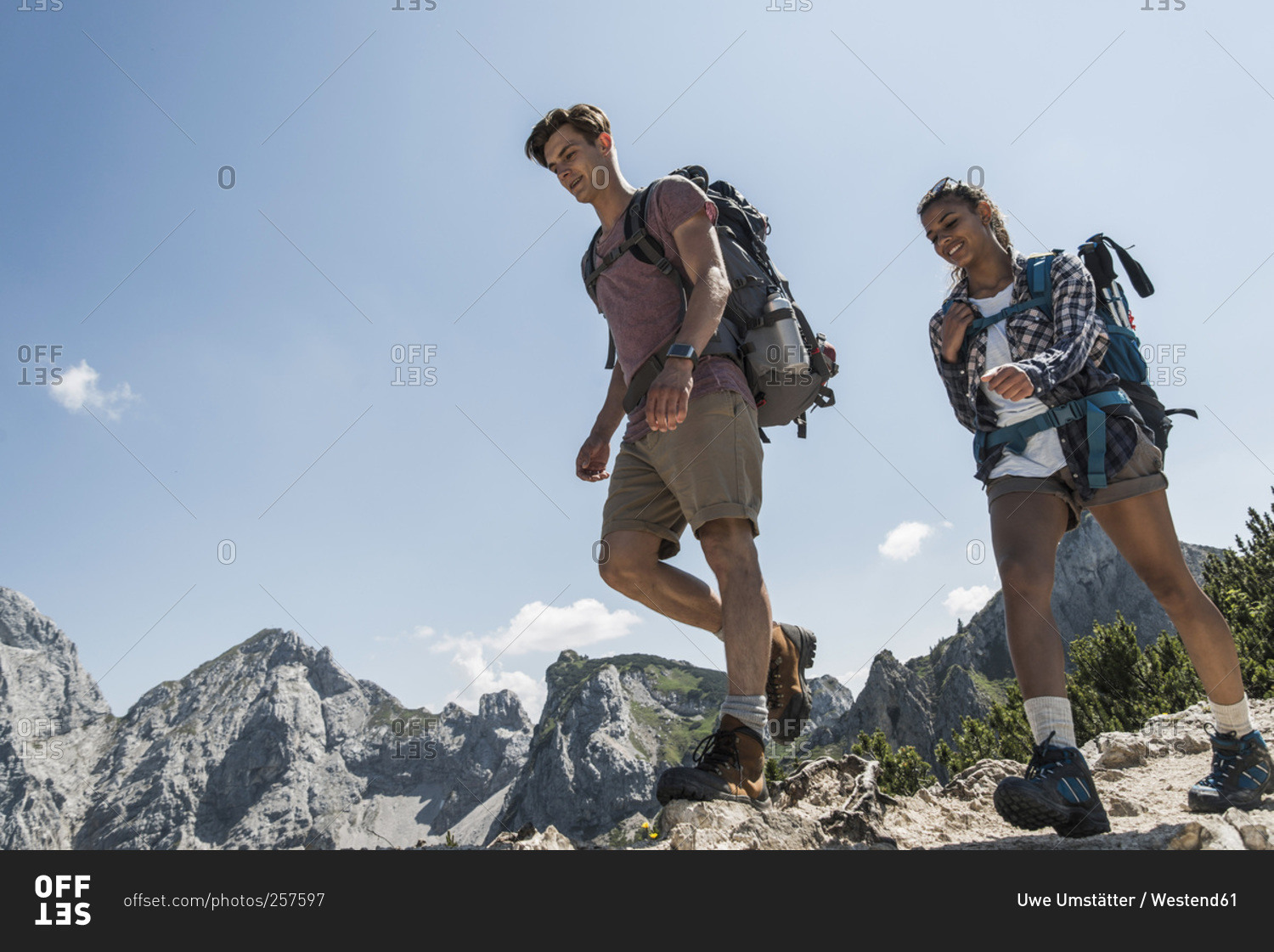 Young couple hiking on mountain trail, Tannheimer Tal