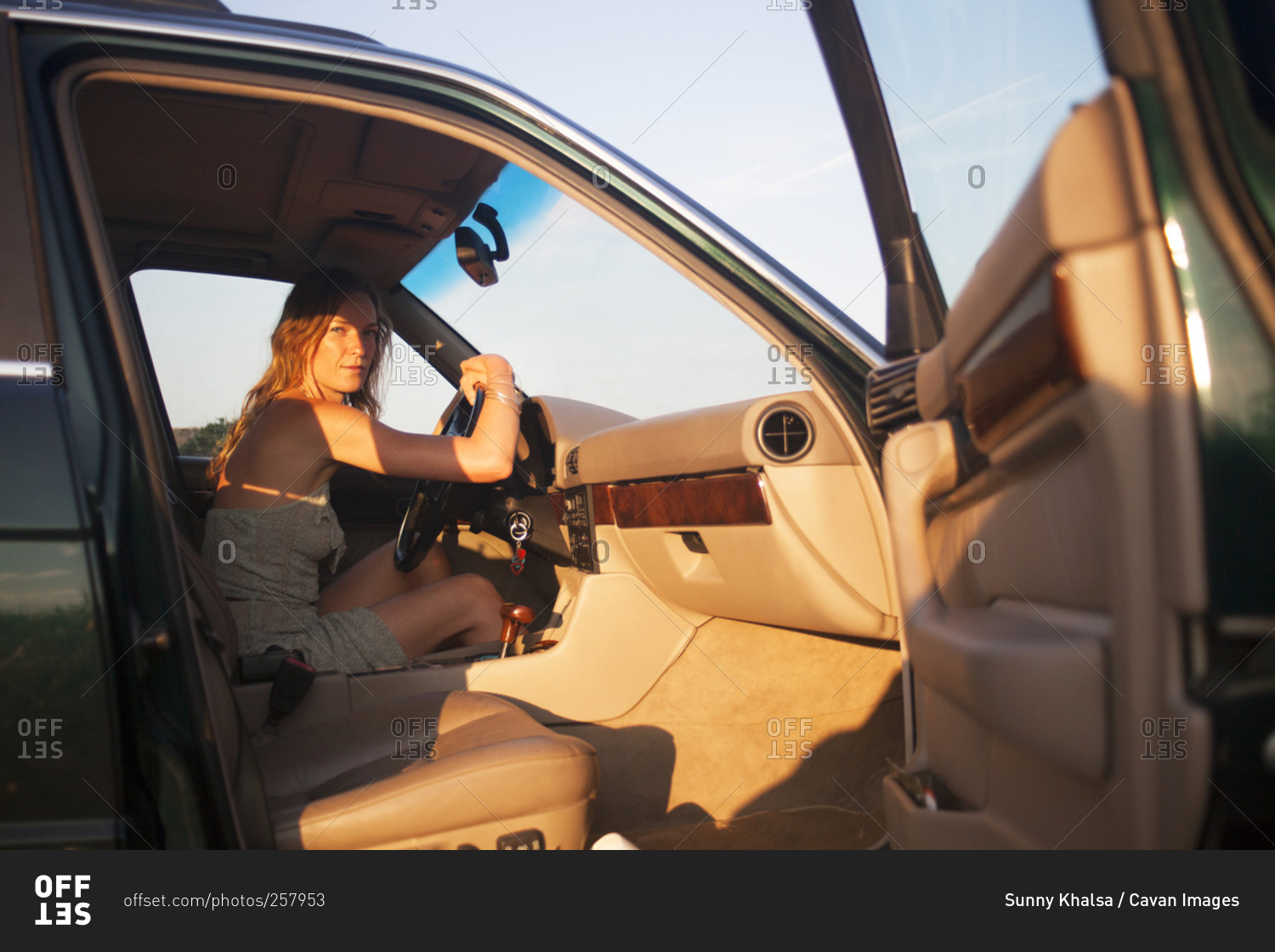 Woman sitting in the driver's seat of a vehicle stock photo OFFSET
