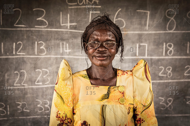 Mede, Uganda - March 5, 2015: Ugandan student standing in front of a chalkboard