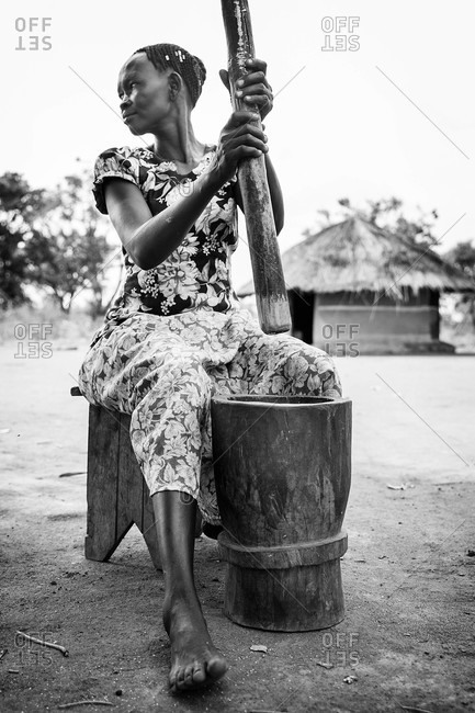 Paicho, Uganda - March 5, 2015: Woman working with a mortar and pestle
