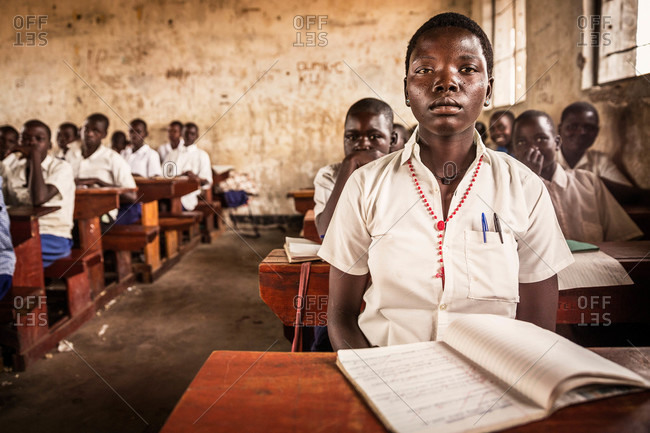 Paicho, Uganda - March 5, 2015: Ugandan girl sitting at a desk in a classroom