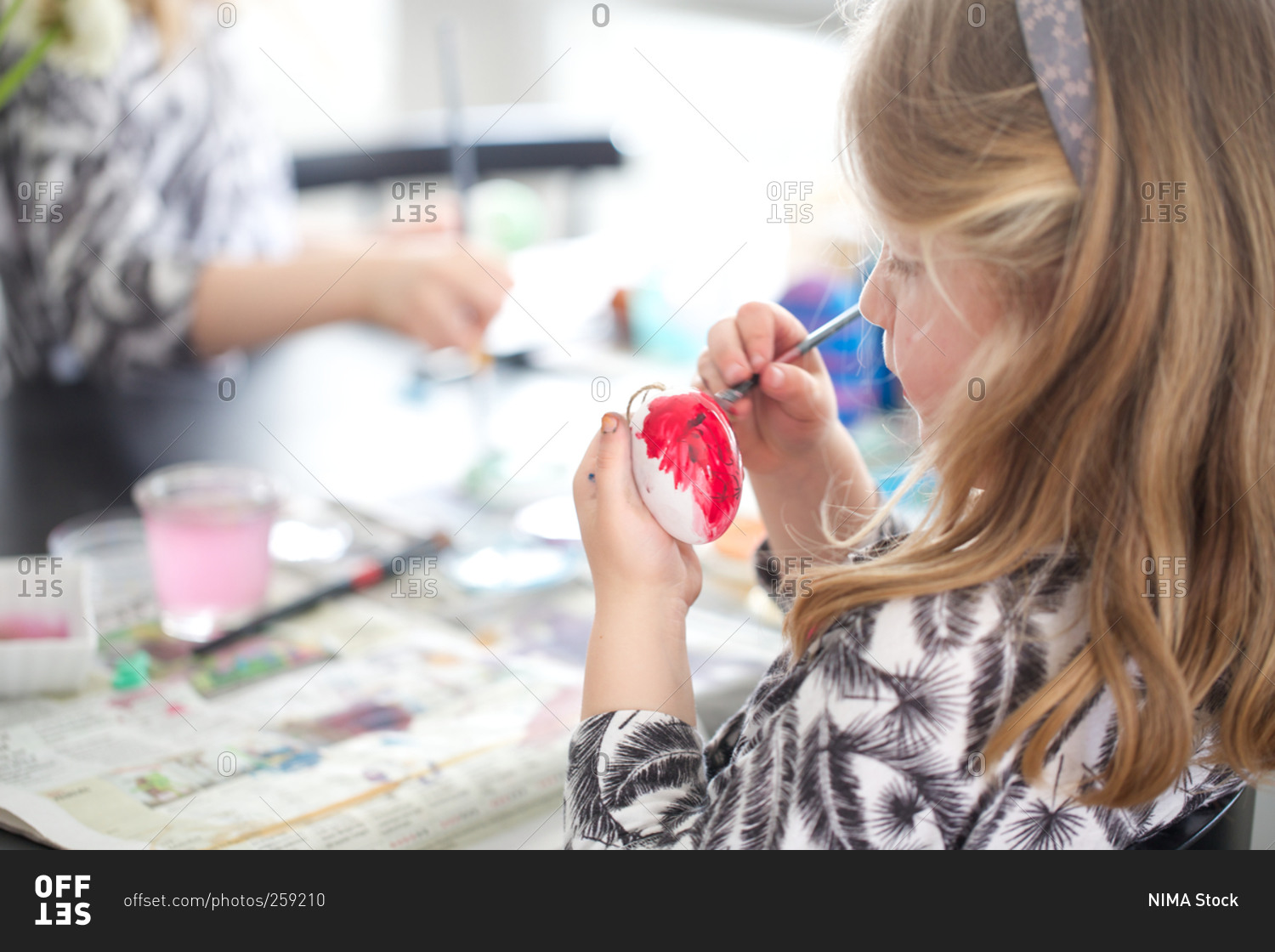 Girl painting Easter eggs Easter celebration