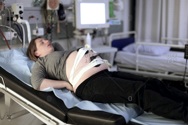Pregnant woman on maternity ward examination bed