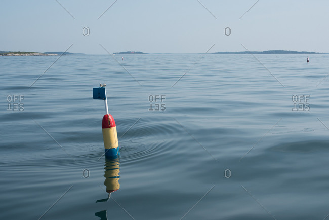 Buoy With Flag Floating In Calm Water Stock Photo - Offset