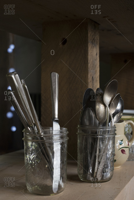 Spoons and butter knives in mason jars